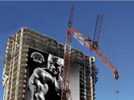 Powerhouse Gym Man Lifting Billboard Ad Talk Cock Sing Song